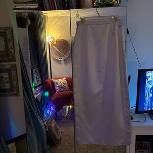 Carefully stitched, lining attached, satin skirt silvery powder blue, side slit.